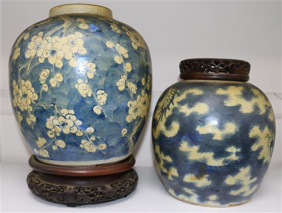 Two Chinese blue and white ovoid jars, 19th century, largest 23cm, carved wood stands and cover